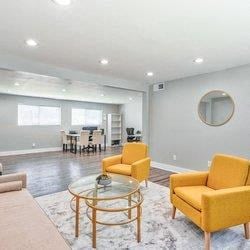 a living room with couches and chairs and a glass table at Uphill Flats, Decatur