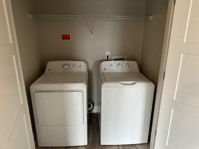 two washer and dryers in a room with a door