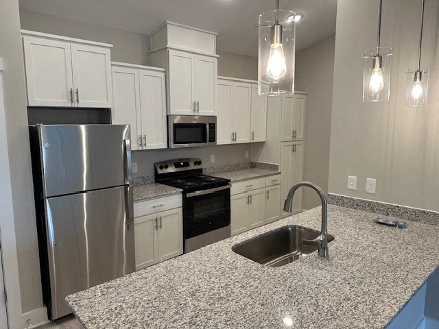 a kitchen with stainless steel appliances and granite counter tops