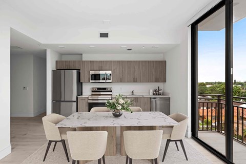 A modern kitchen with a table and chairs.