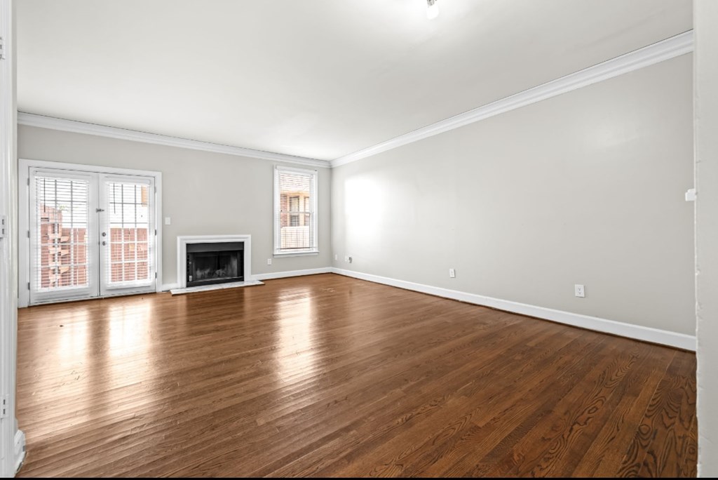 A room with wooden floors and a fireplace.