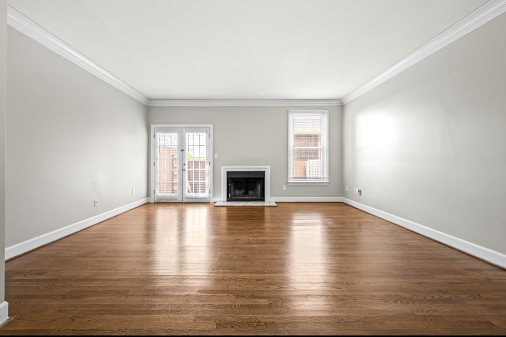 A room with a fireplace and a window.