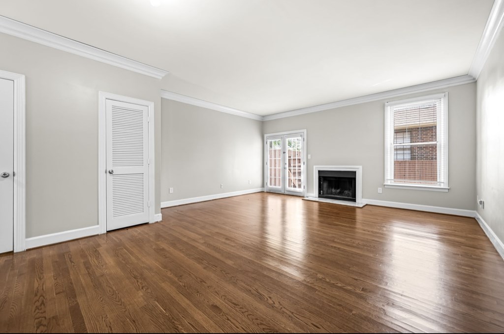 A room with wooden floors and a fireplace.