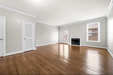 A room with wooden floors and a fireplace.