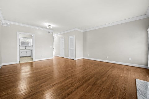 A room with wooden floors and white walls.