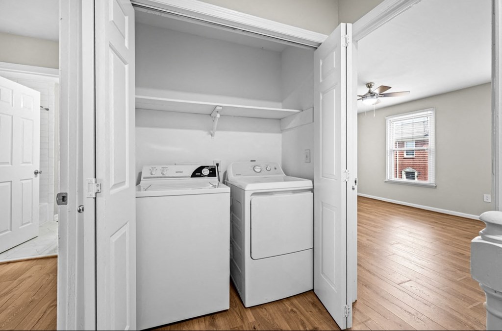 A laundry room with a washer and dryer in it.