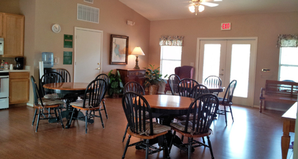 a dining room with a table and chairs in a living room