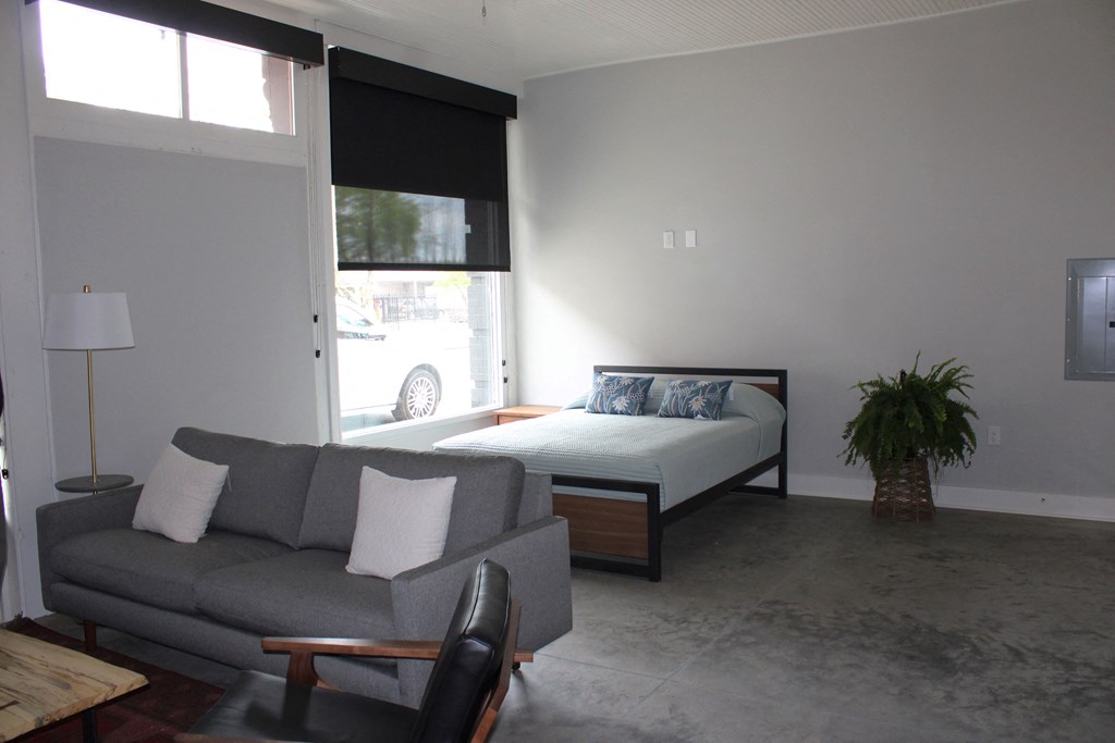 a bedroom with a couch and a bed in a room