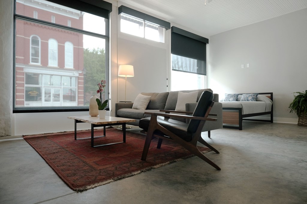 a living room with a couch and a chair and a table