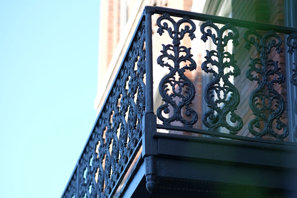 a balcony of a building with wrought iron railing