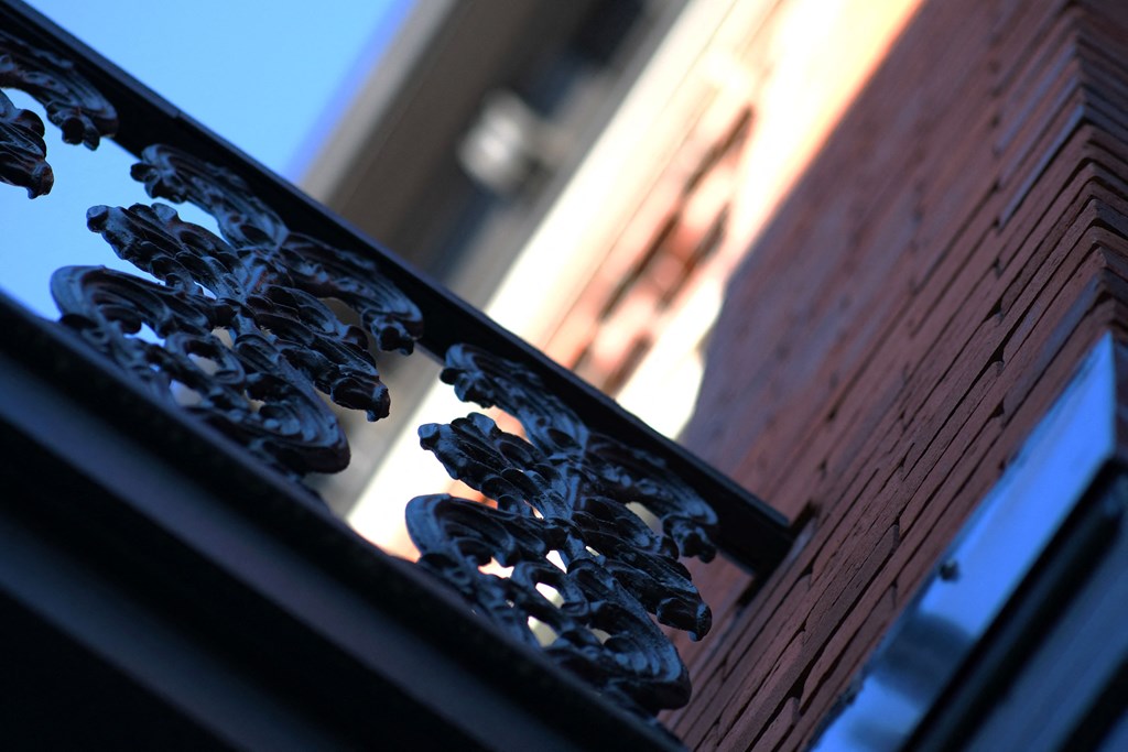 a window with a reflection of a building in it