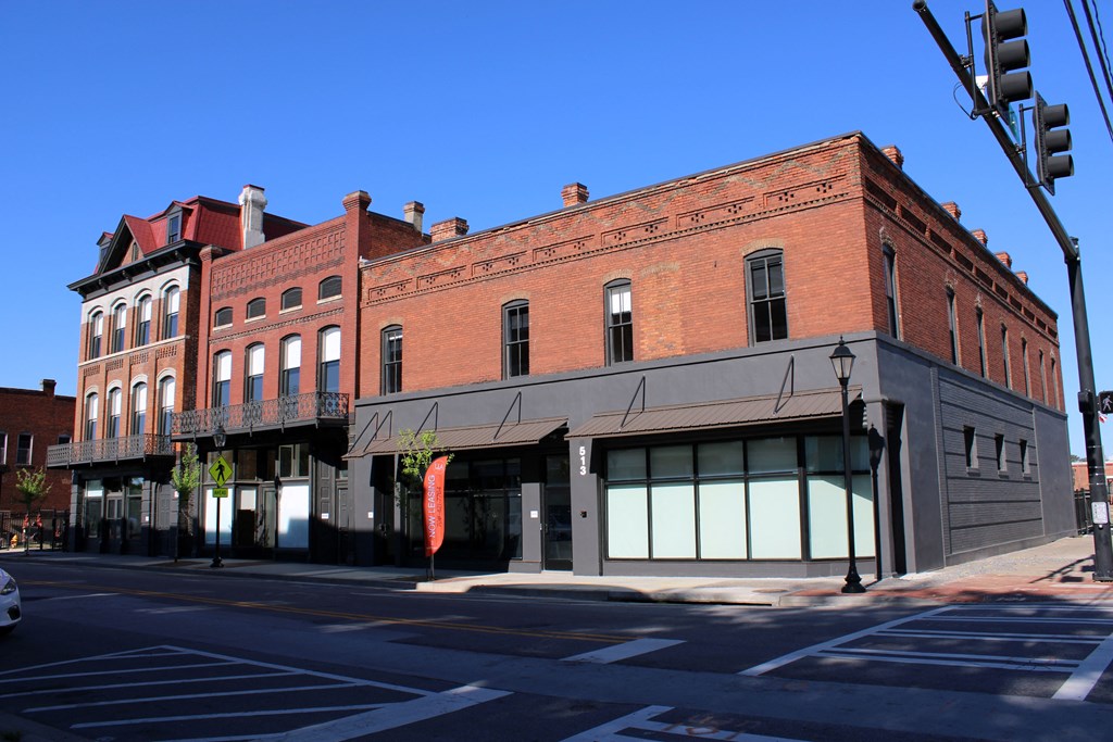an old brick building on the corner of a city street