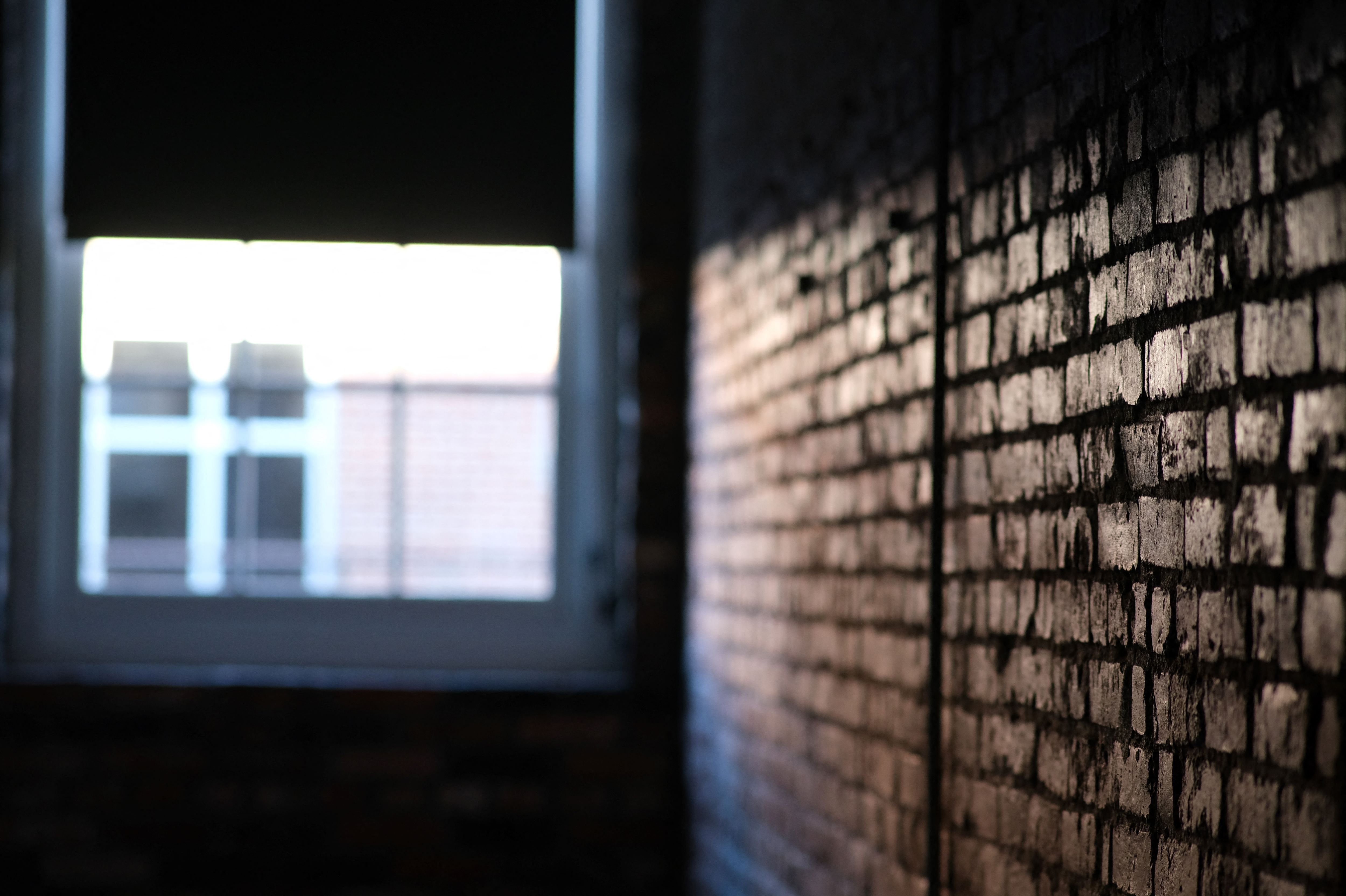 a brick wall with a window in it