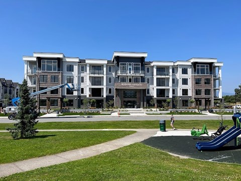 an apartment building with a playground in front of it