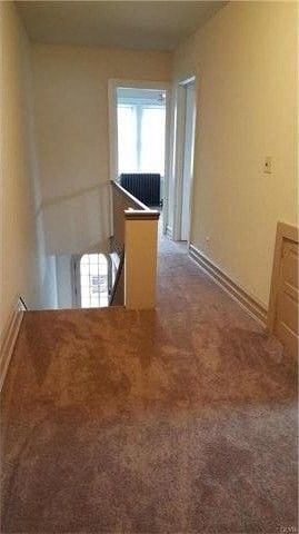 an empty living room with a box on the floor