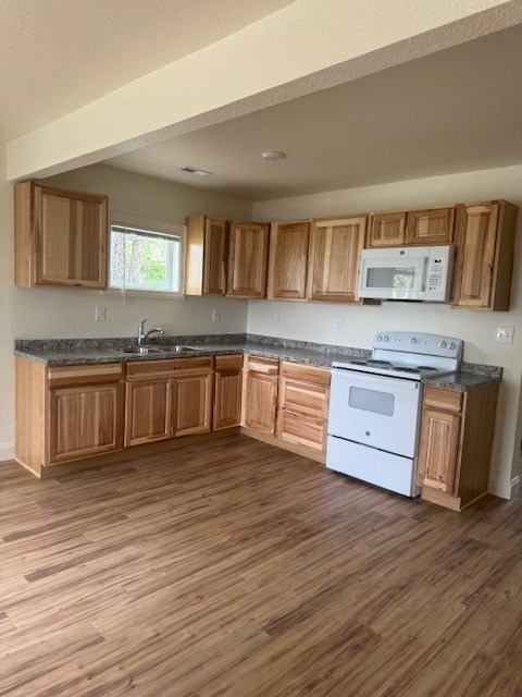 A kitchen with wooden cabinets and a white oven.