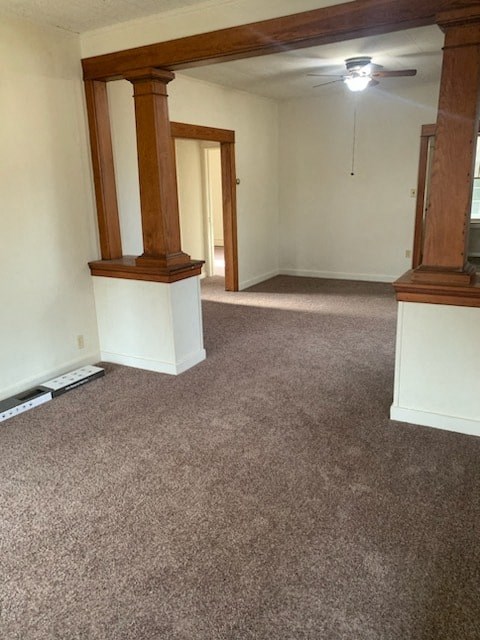 an empty living room with carpet and a ceiling fan