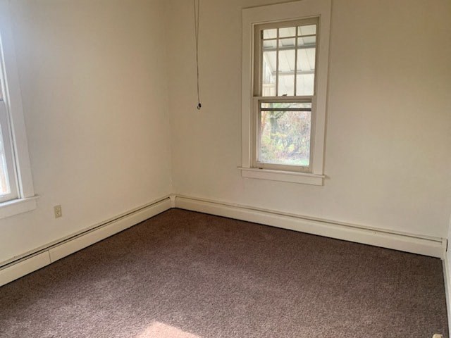 an empty room with a window and a carpet