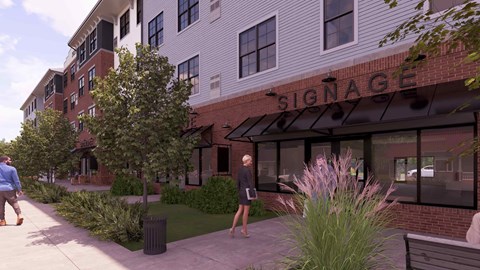 A woman in a black dress is walking past a building with the word "Signage" on it.