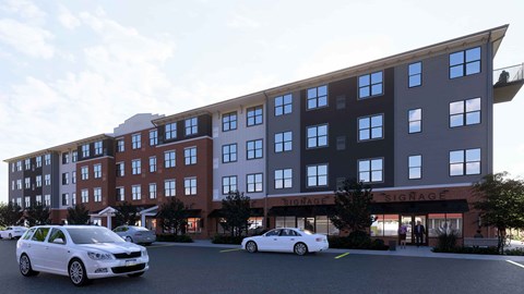 Two cars are parked in front of a building with the name SIGNAGE on it.