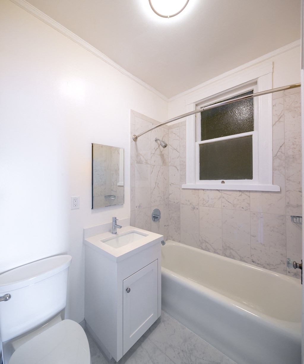 a small bathroom with a sink toilet and bath tub