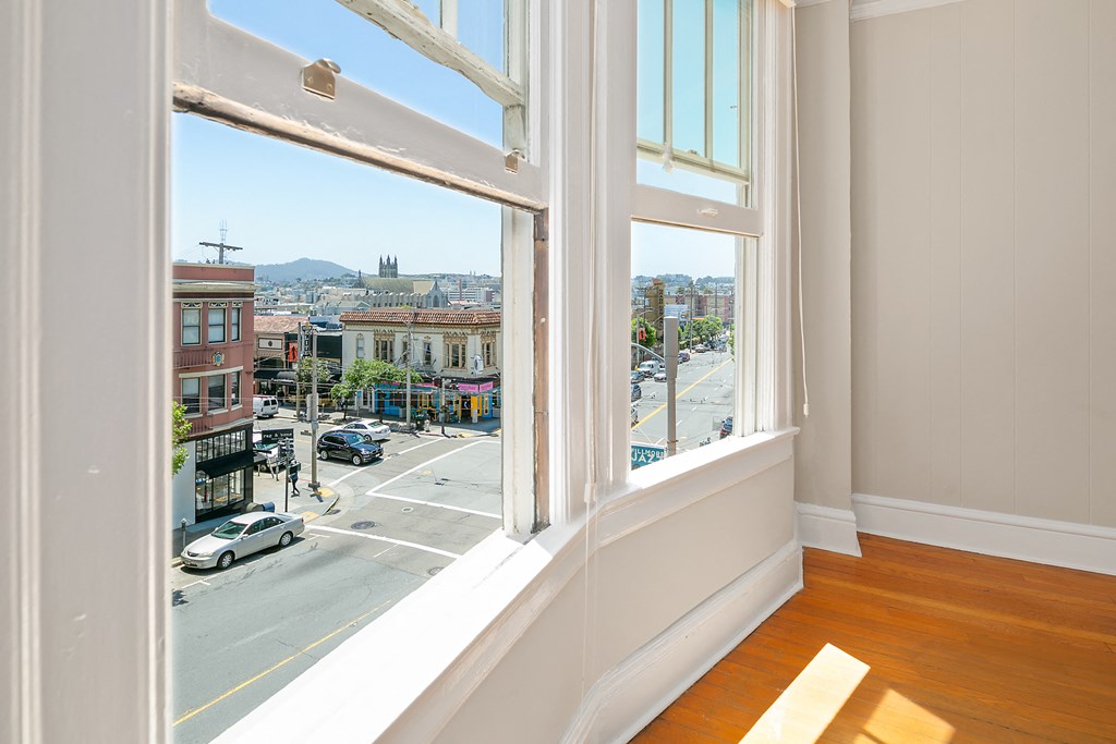 a room with a large window overlooking a city street