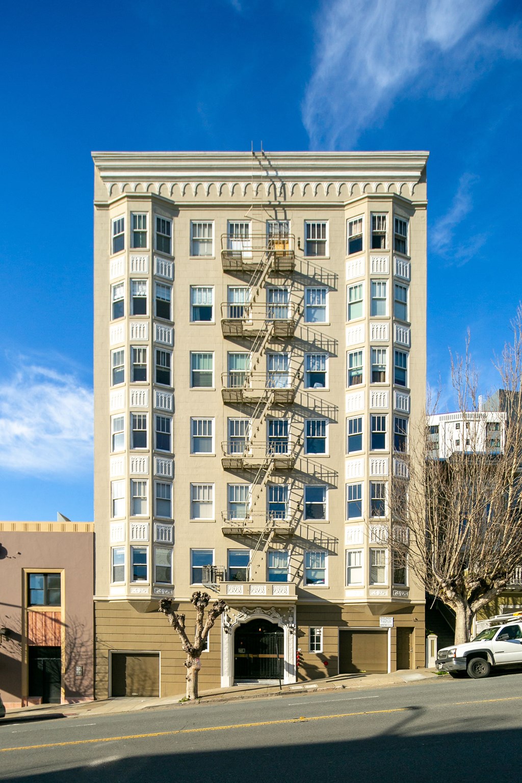 a large building with a fire escape on the side of a street