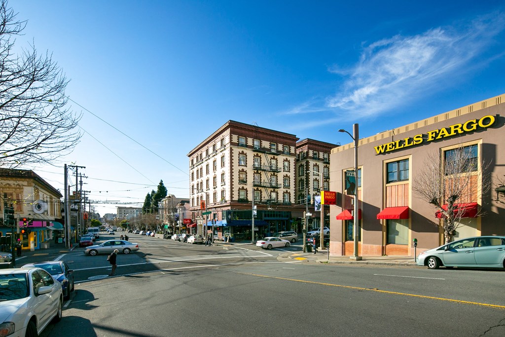 a city street with cars parked on the side of a building