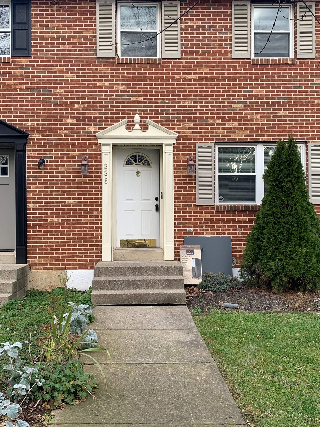the front door of a brick house with a white door
