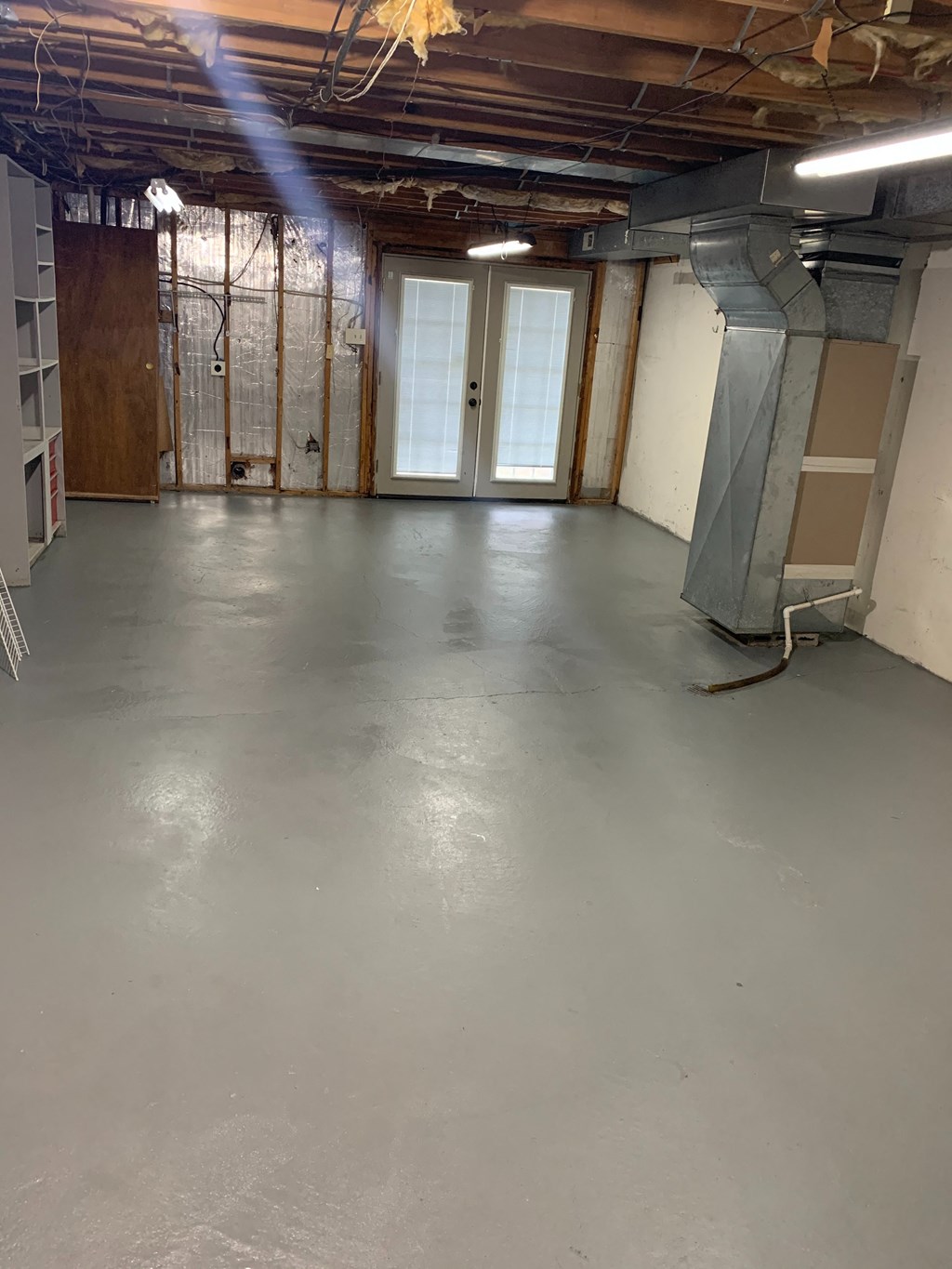 a large room with a concrete floor and a door