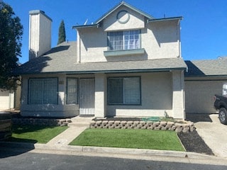 a white house with a yard in front of it