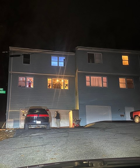 a car parked in front of a house at night