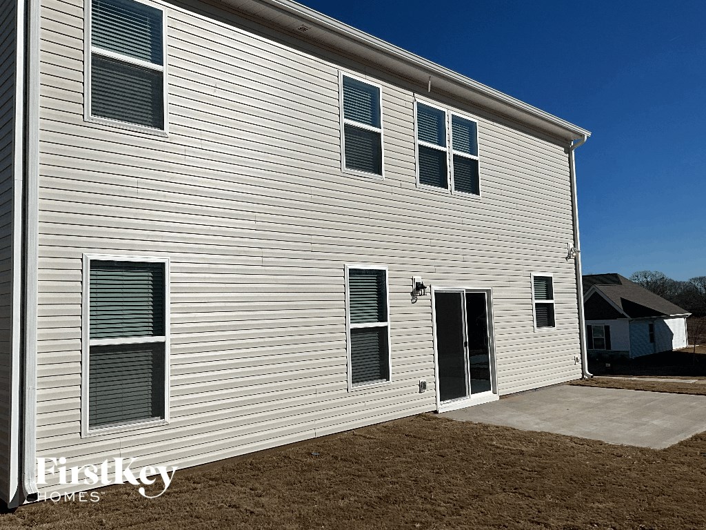 the side of a white house with a open door