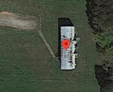 A boat with a red marker is in the water.