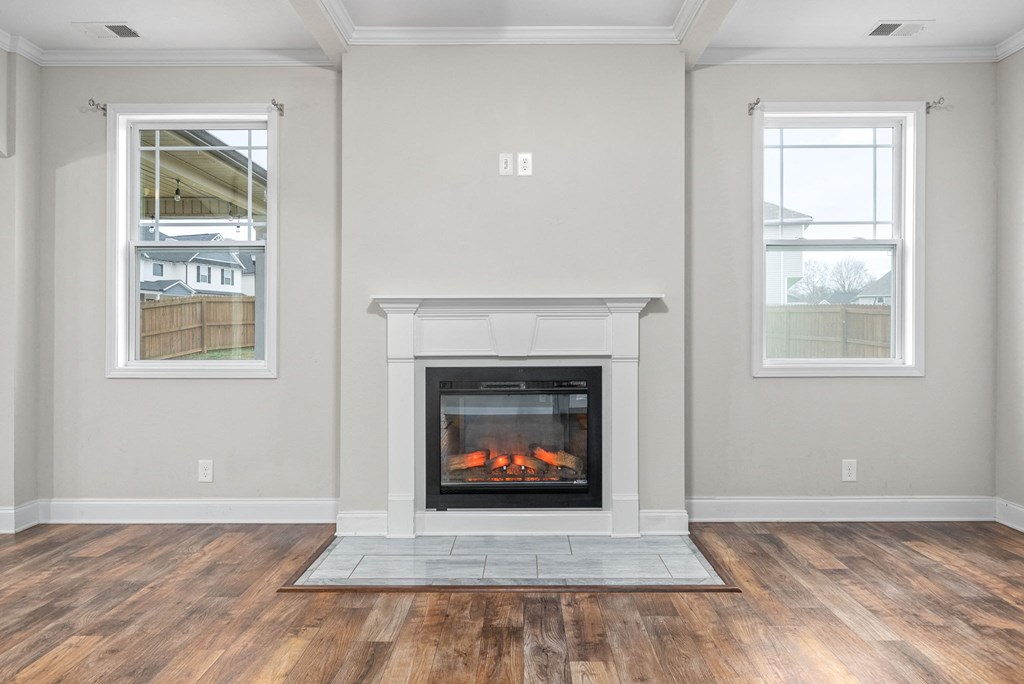 the renovated living room of a house with a fireplace