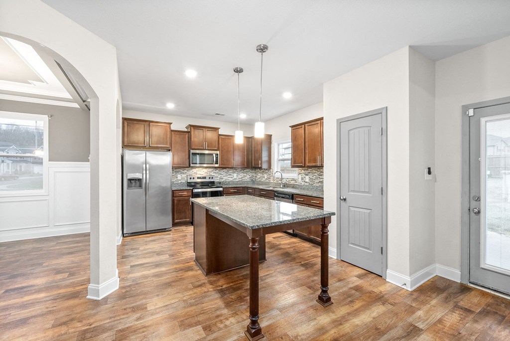 a kitchen with an island in the middle of it