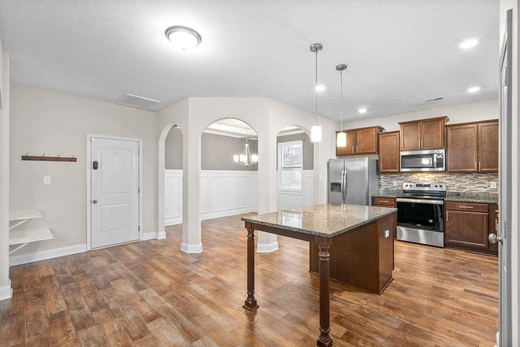a kitchen with an island in the middle of it