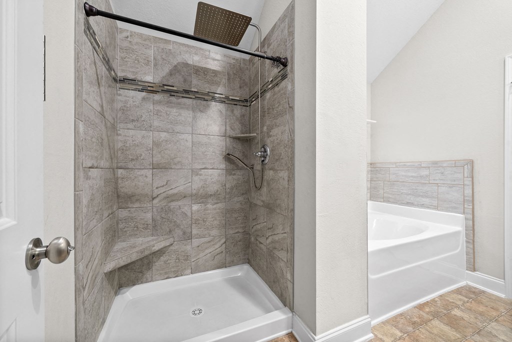 a bathroom with a shower and a tub and a sink