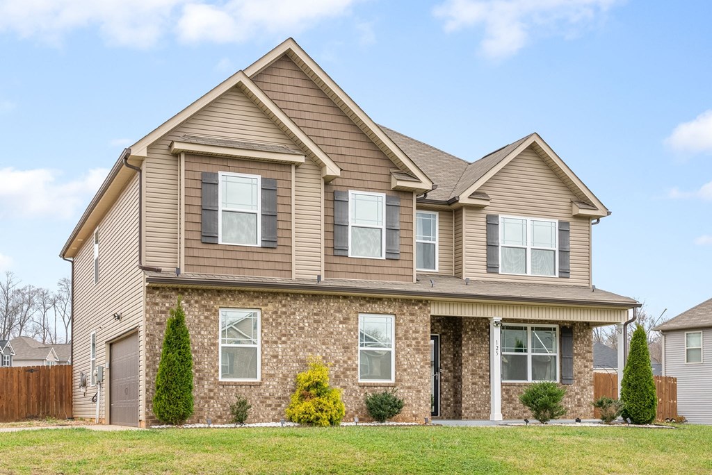 a tan house with brown siding and a brown roof