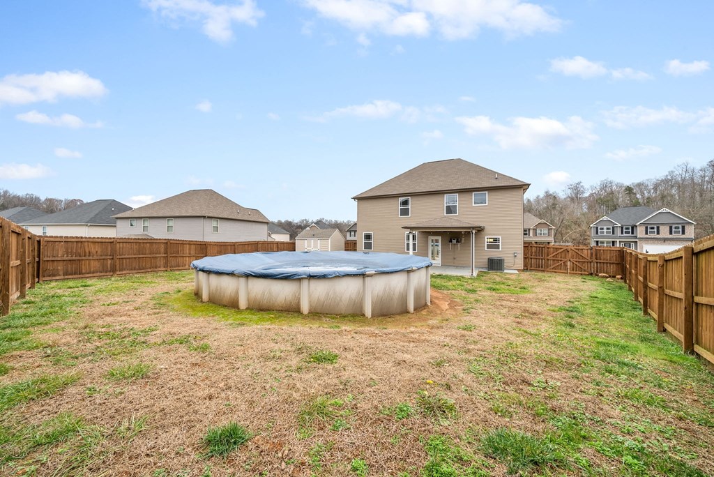 a backyard with a pool and a house