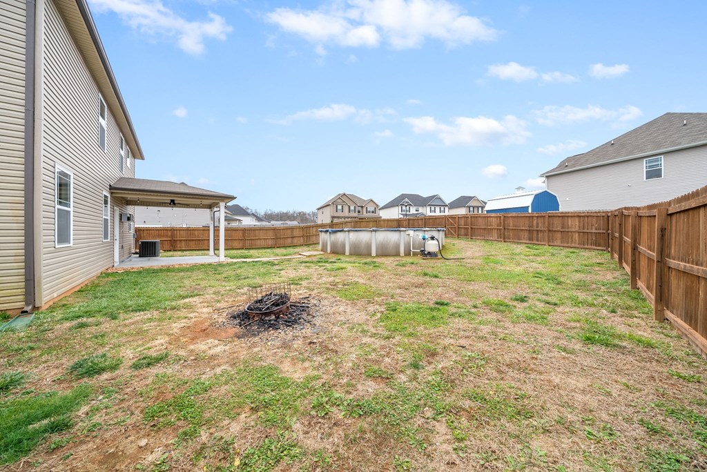a backyard with a fence and a house