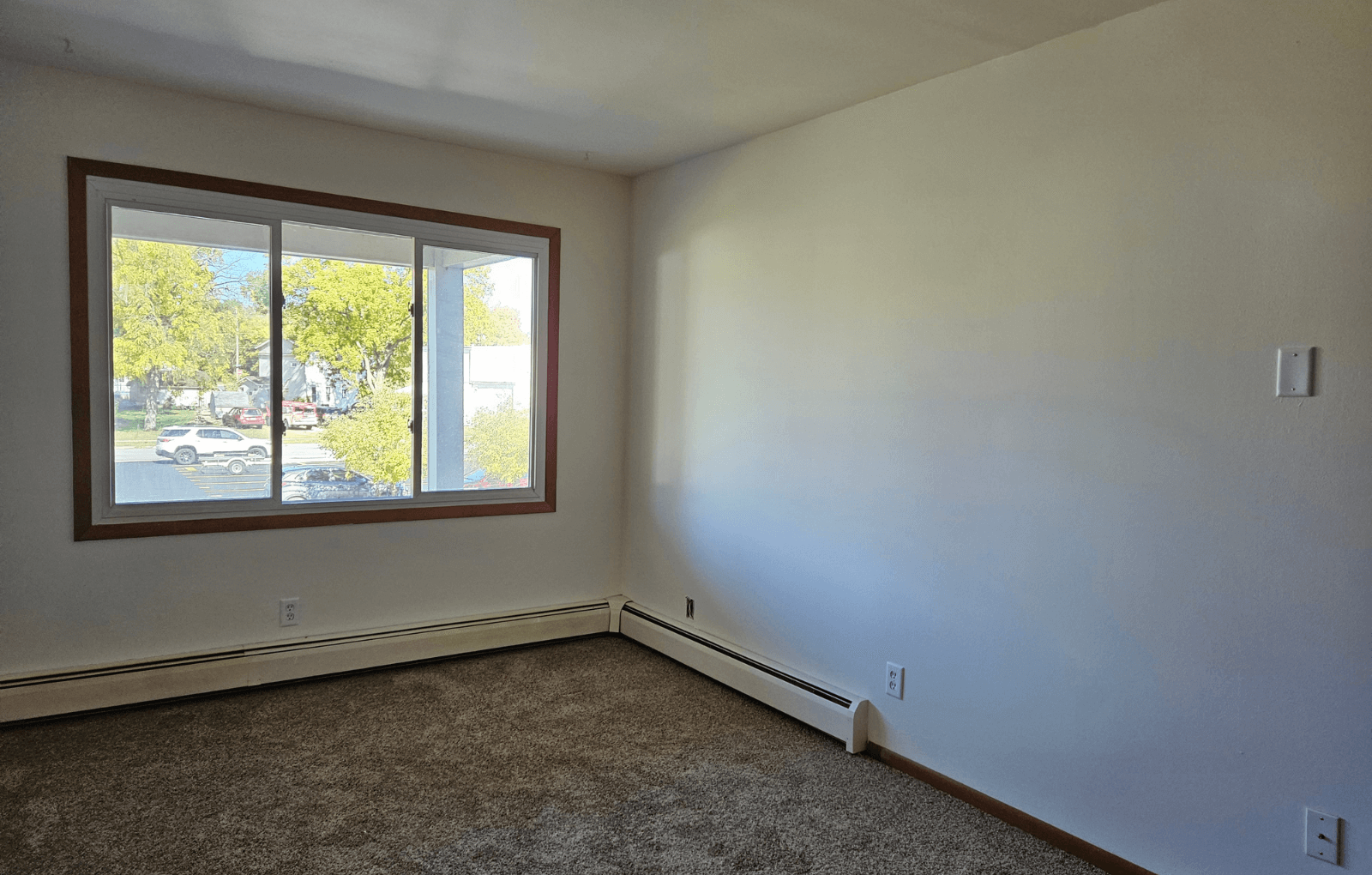 an empty living room with a large window
