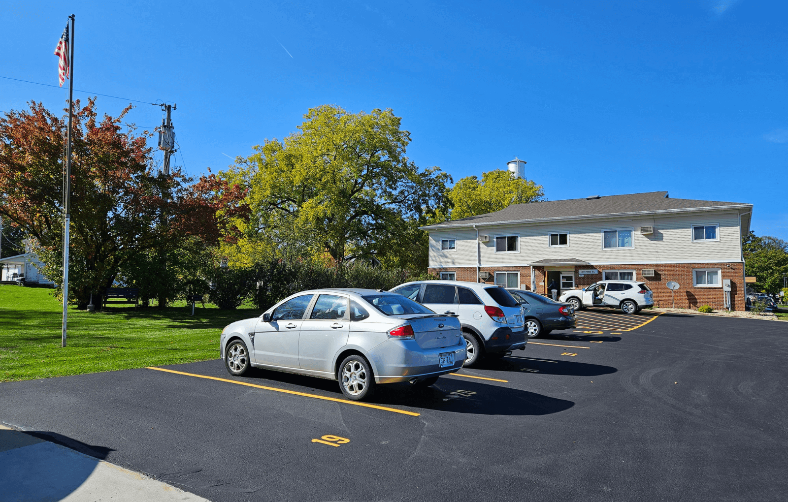 a parking lot with cars in front of a house