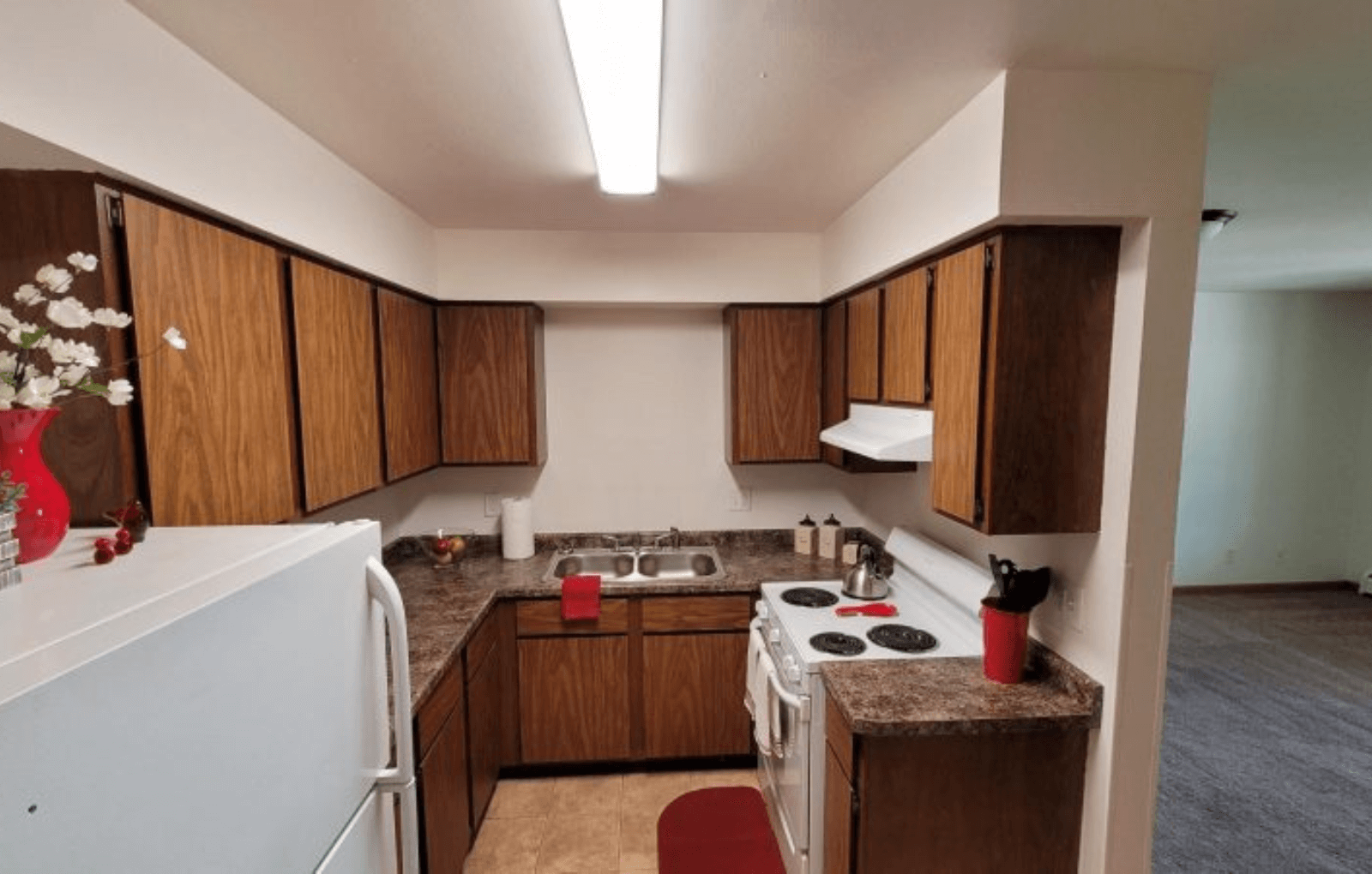 a kitchen with wooden cabinets and a stove and a refrigerator