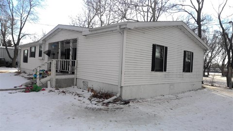 a small white house in the snow