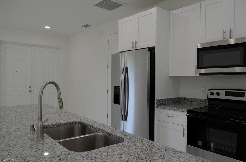 a kitchen with a sink and a refrigerator