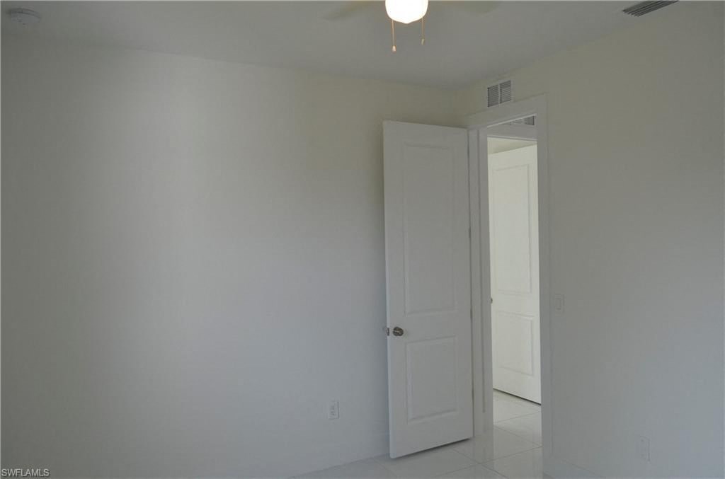 a white room with a white door and a white closet