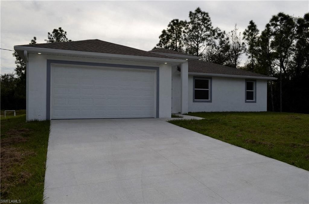 a white house with a driveway and a garage door