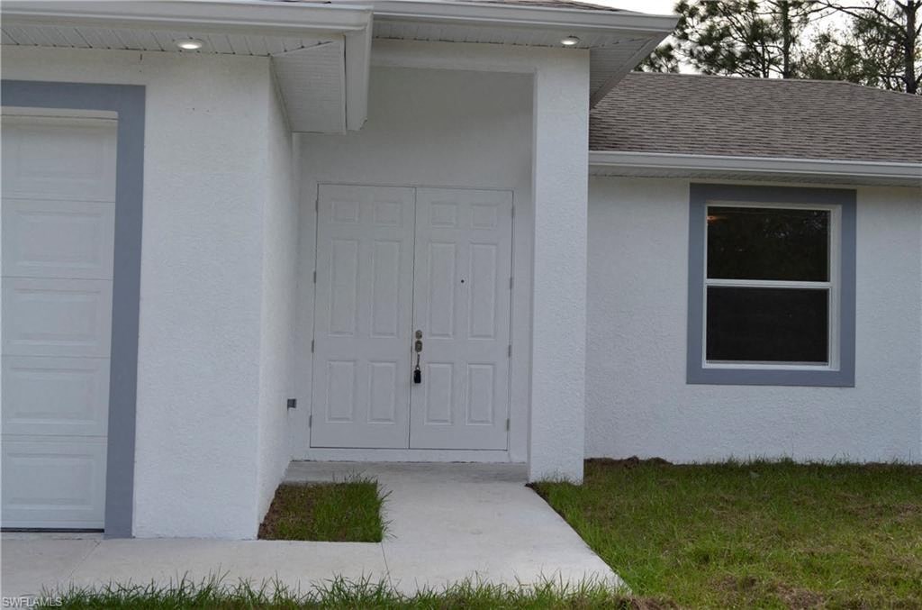 a white house with a white door and a sidewalk