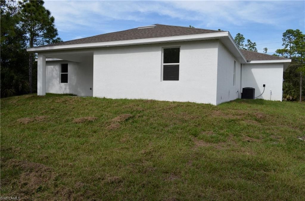 a small white house on a grass covered hill